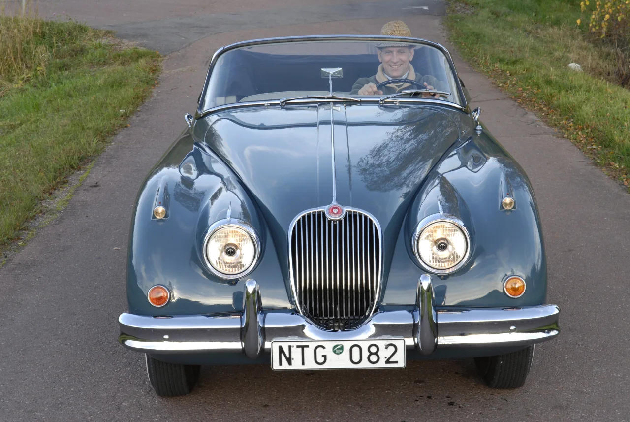 Jaguar XK150 rakt framifrån med en förare bakom ratten